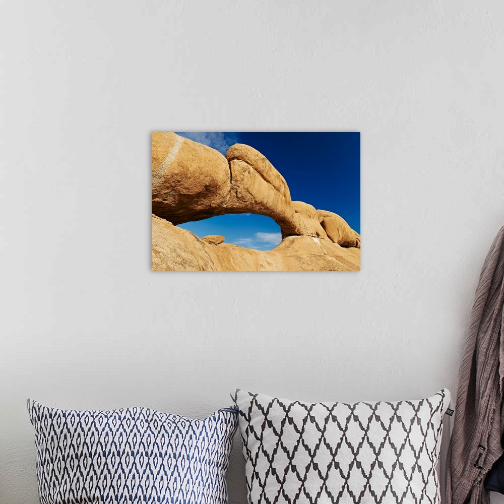 A bohemian room featuring the arch at Spitzkoppe or Spitzkuppe, arid mountain landscape of granite rocks, Matterhorn of Nam...