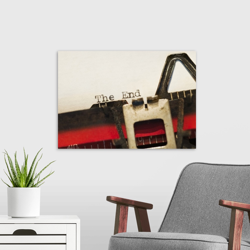 A modern room featuring This picture was taken closely zoomed in on a typewriter that had just written "The End" onto a b...