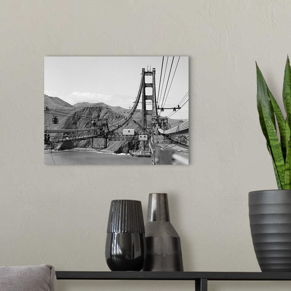 A modern room featuring Looking from San Francisco toward the marine shore at the construction of the Golden Gate Bridge.