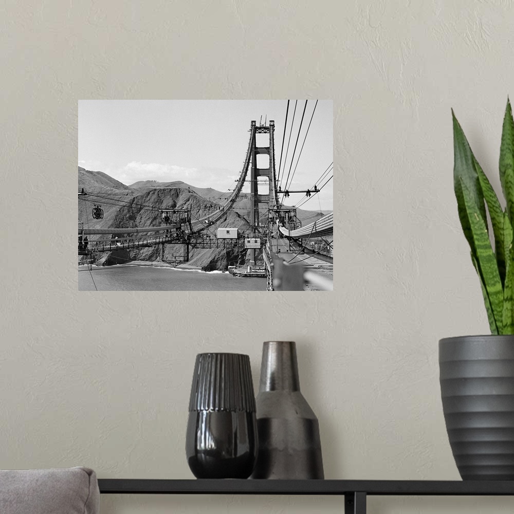 A modern room featuring Looking from San Francisco toward the marine shore at the construction of the Golden Gate Bridge.