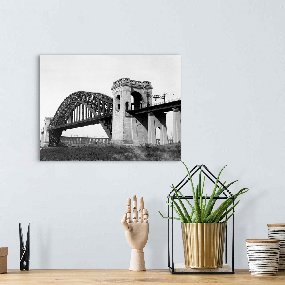 A bohemian room featuring The Hell Gate Bridge links Queens with the Bronx over a channel separating Astoria and Ward's Isl...