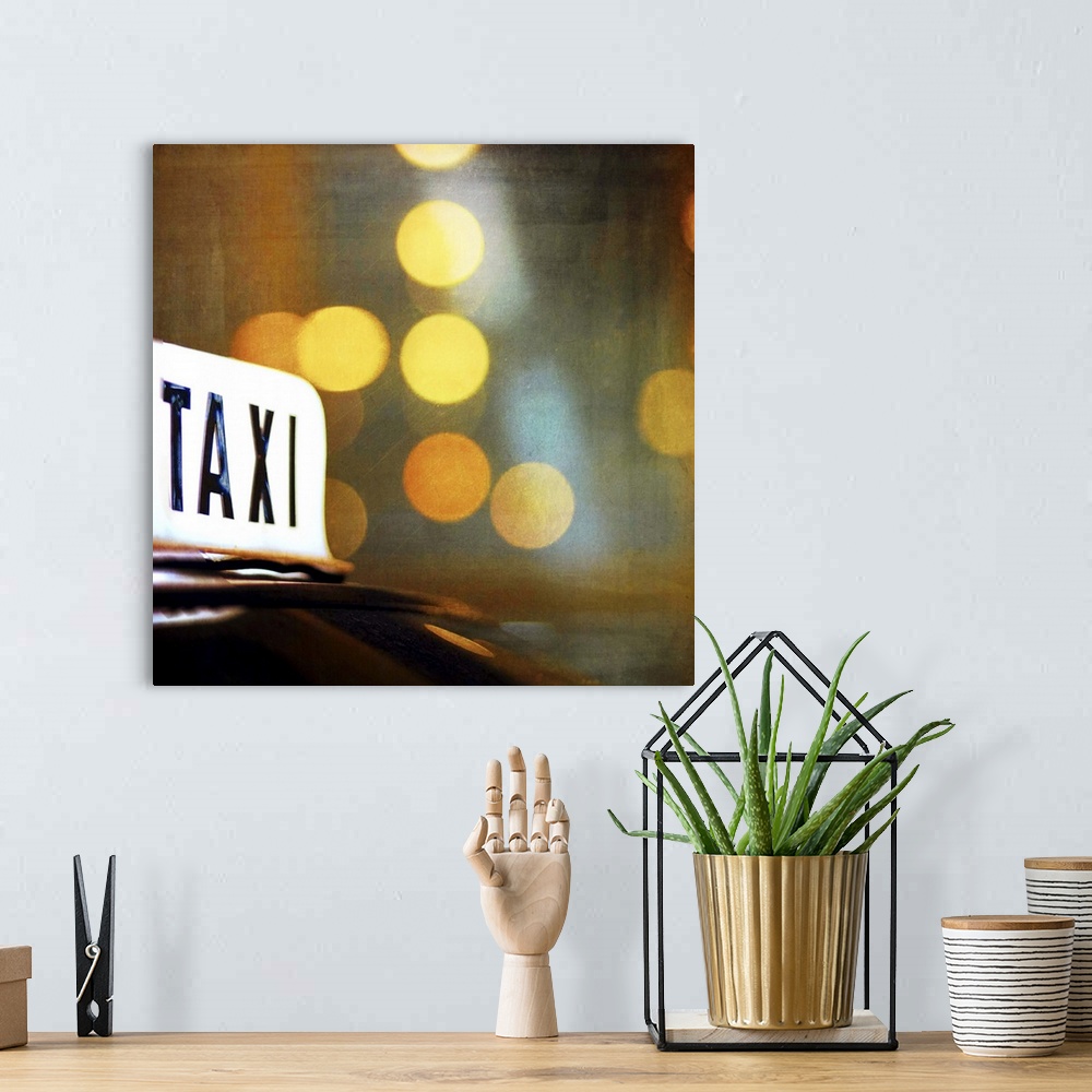 A bohemian room featuring A lit taxi sign is highlighted against the city lights at night.
