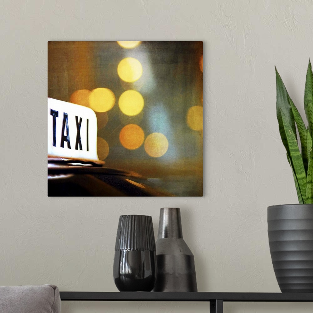 A modern room featuring A lit taxi sign is highlighted against the city lights at night.