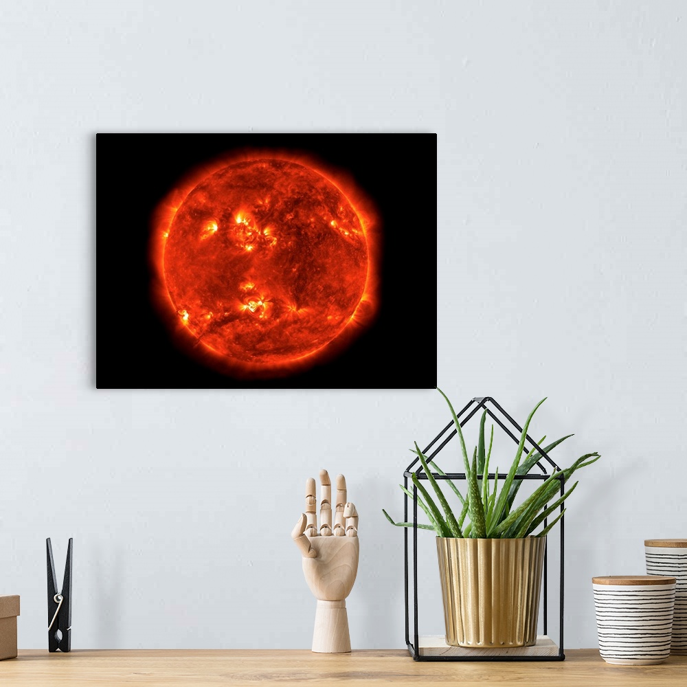 A bohemian room featuring Image of the Sun, constructed from a mosaic of TRACE images.
