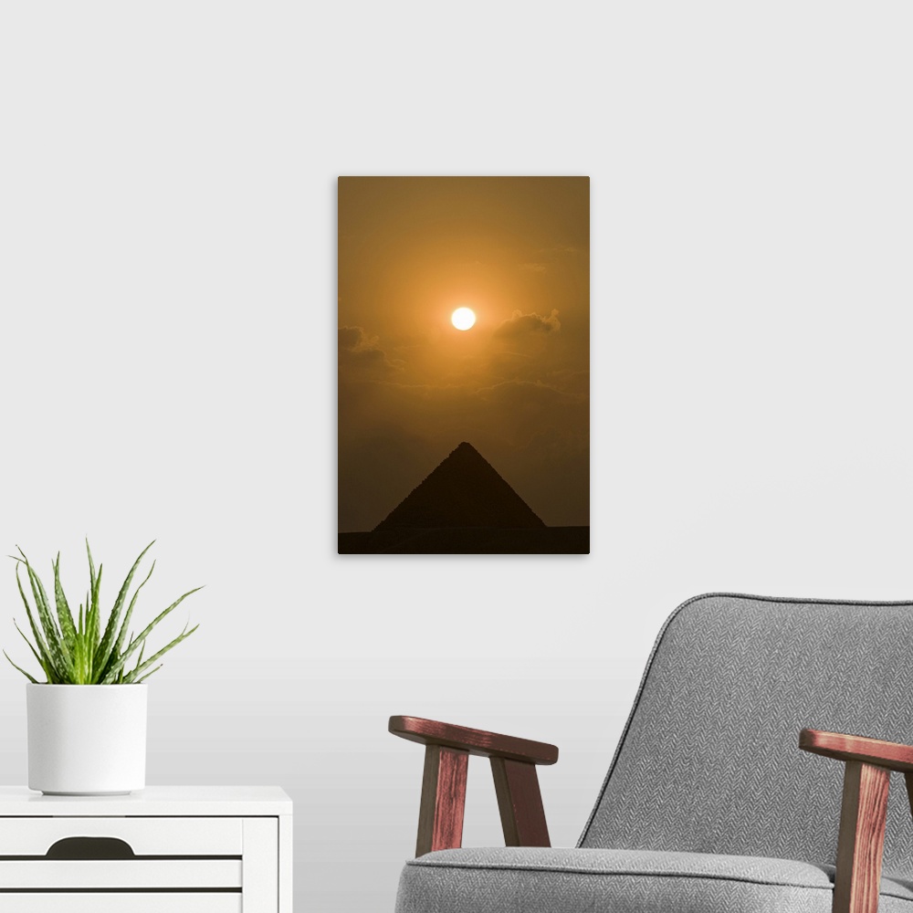 A modern room featuring The sun begins to set above The Great Pyramid of Giza, in Cairo, Egypt.