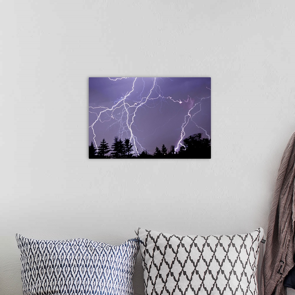 A bohemian room featuring Three frames of lightning hitting Cedar Hills area.
