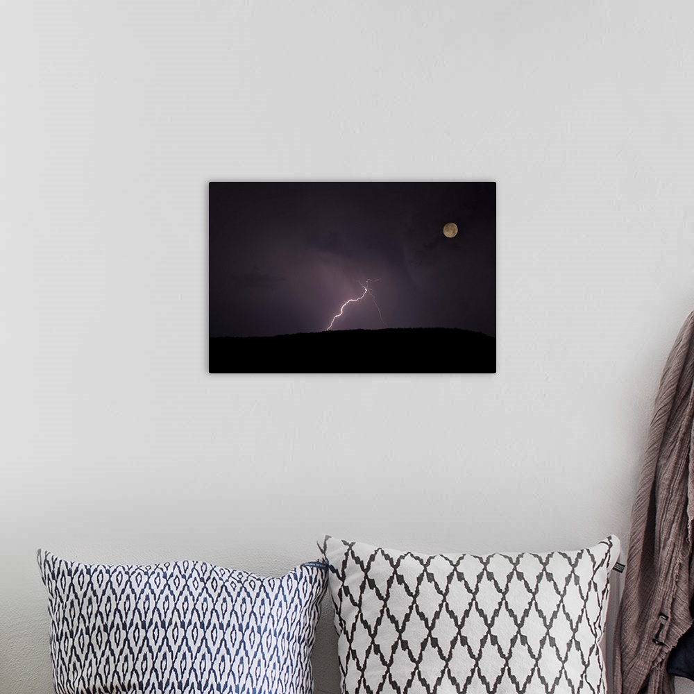 A bohemian room featuring Thunderstorm, thunderbolt lightning, flash over mountain and moon at night.