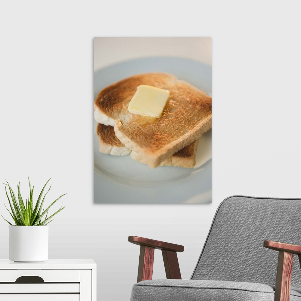 A modern room featuring Close up of toasts with butter on plate