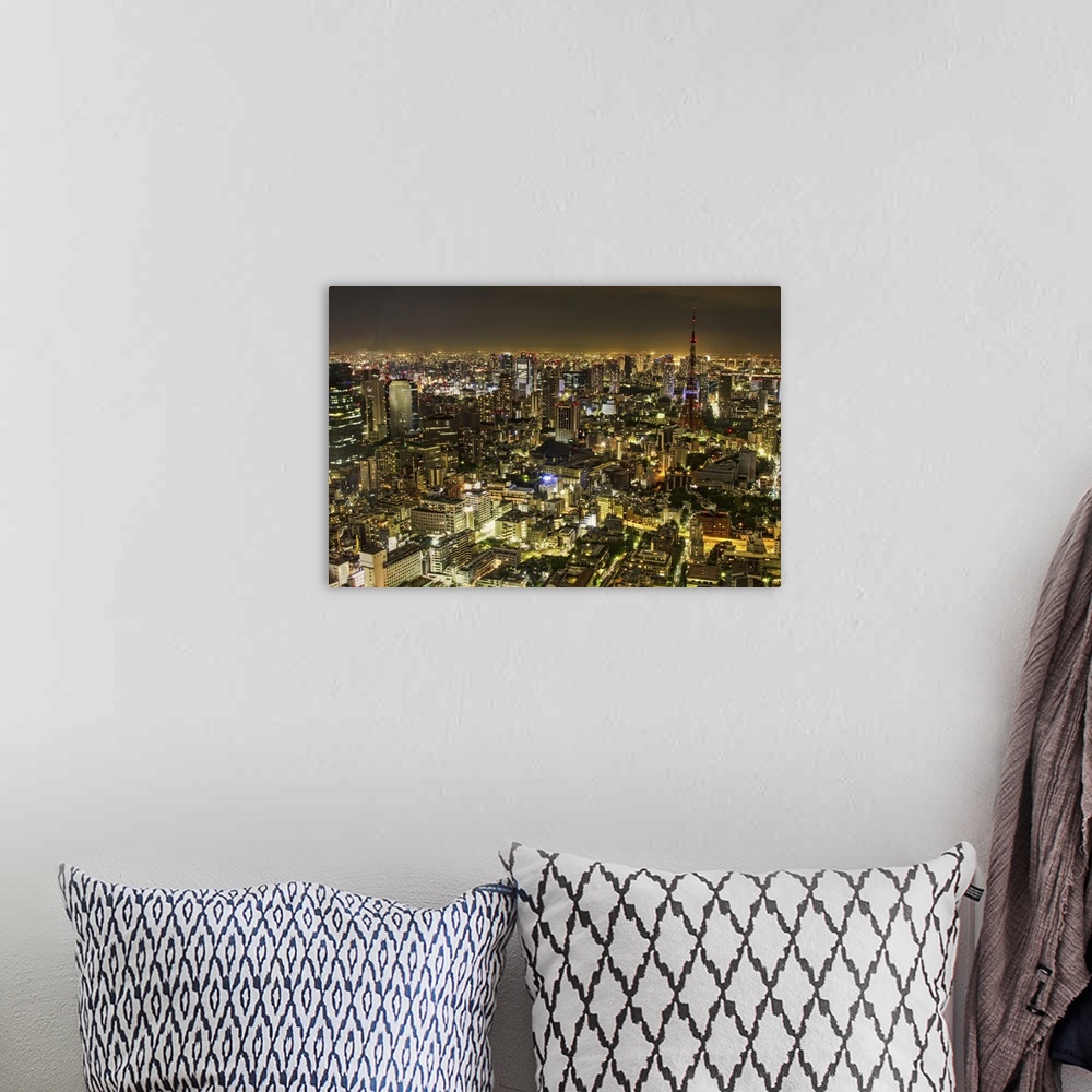 A bohemian room featuring Horizontal, big aerial photograph of the city of Tokyo, brightly lit at night.