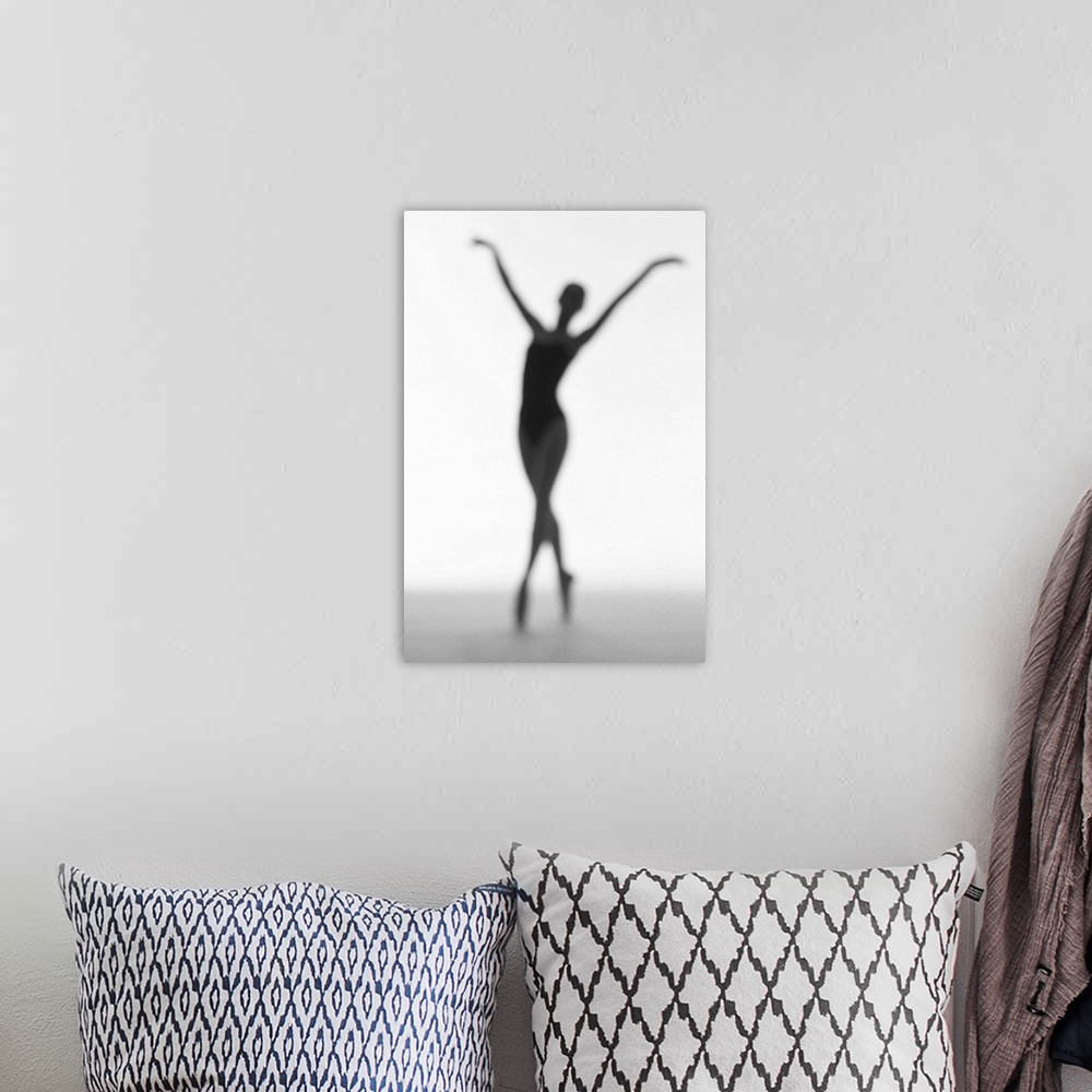 A bohemian room featuring toned silhouette of a young woman performing ballet