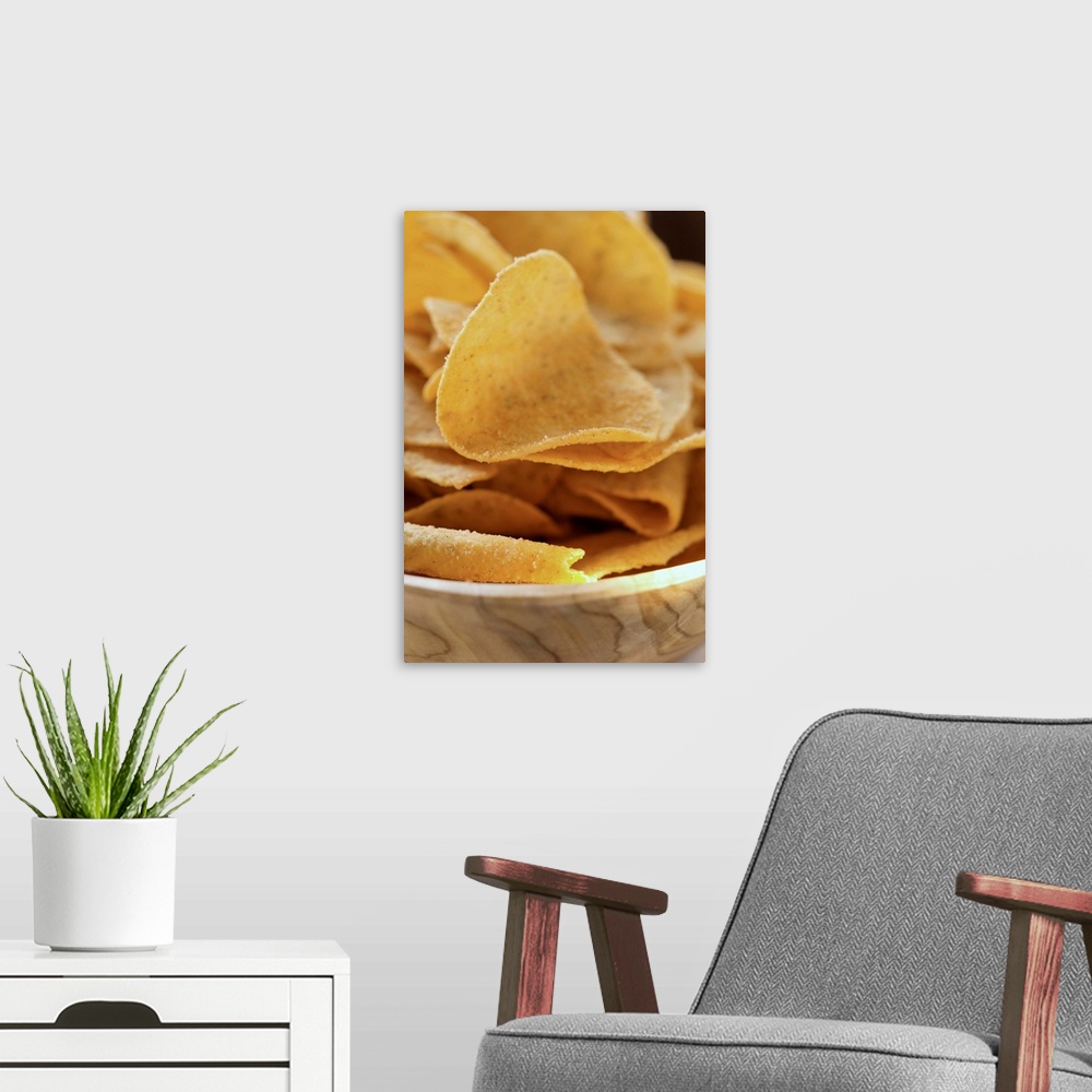 A modern room featuring Tortilla chips in wooden bowl