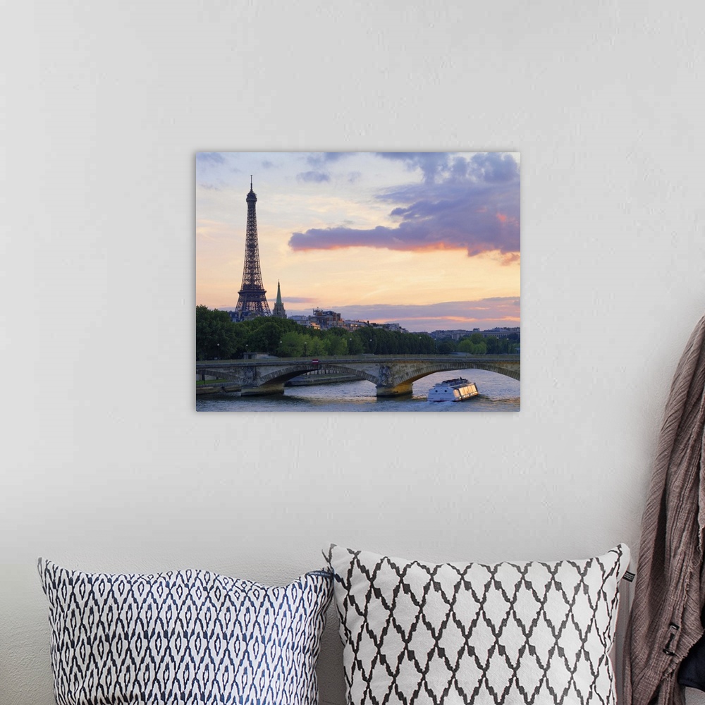A bohemian room featuring France,Paris,tour boat on River Seine,Eiffel Tower behind at dusk