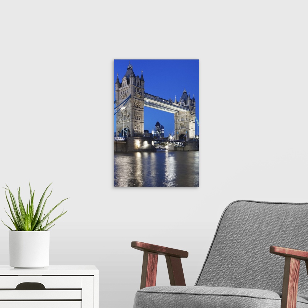 A modern room featuring Tower Bridge at dusk; London; England
