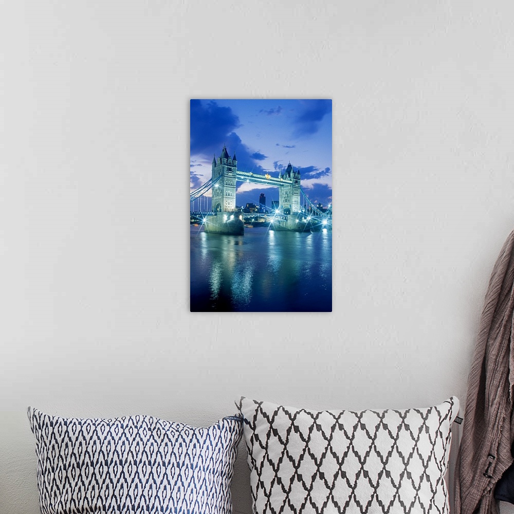A bohemian room featuring Vertical photograph on a large wall hanging of the Tower Bridge, lit up at night, the London skyl...