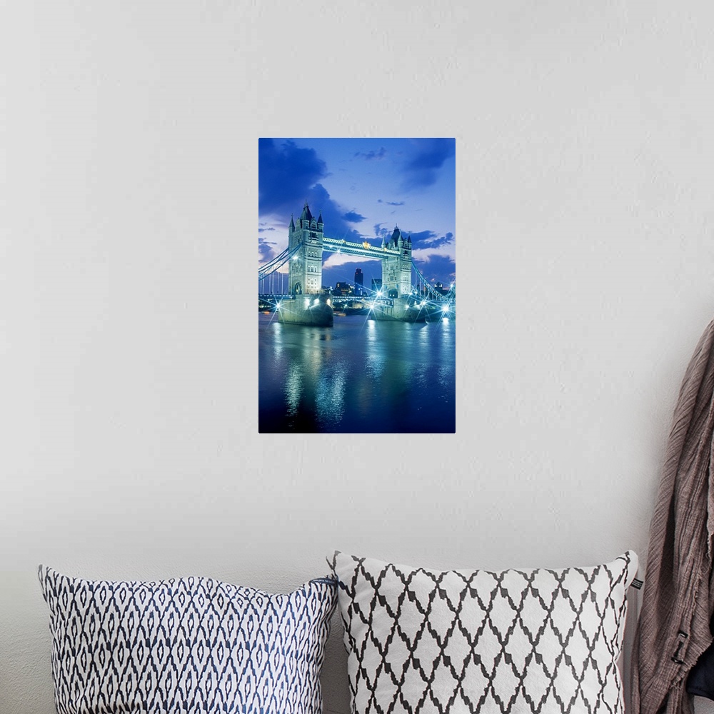 A bohemian room featuring Vertical photograph on a large wall hanging of the Tower Bridge, lit up at night, the London skyl...