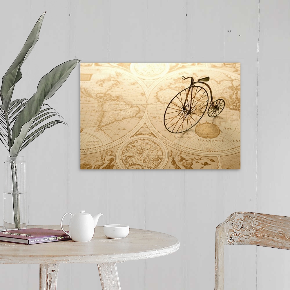 A farmhouse room featuring An antique toy bike on top of an old map of the world.