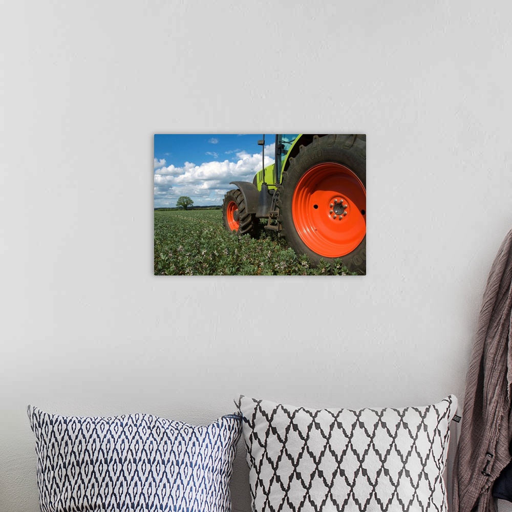 A bohemian room featuring Tractor driving through crops