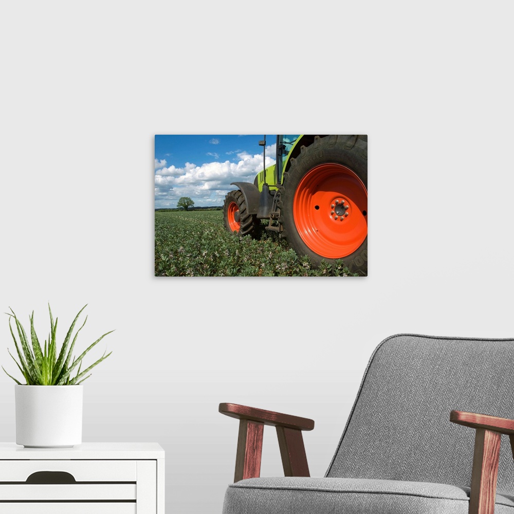 A modern room featuring Tractor driving through crops