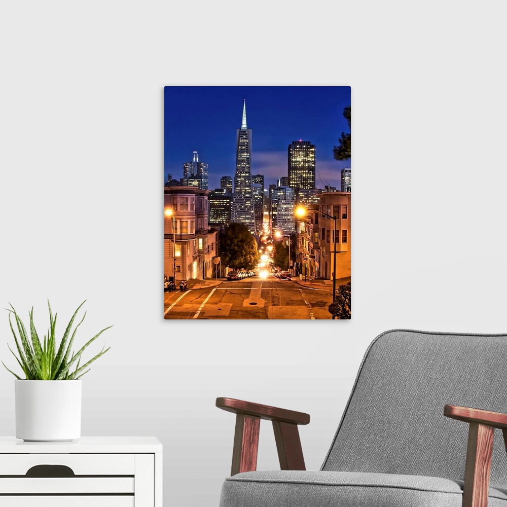 A modern room featuring Transamerica pyramid during blue hour seen from Montgomery street.