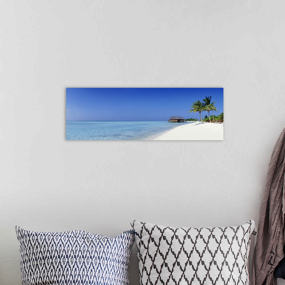 A bohemian room featuring Panoramic image of a tropical beach with white sand and turquoise water.
