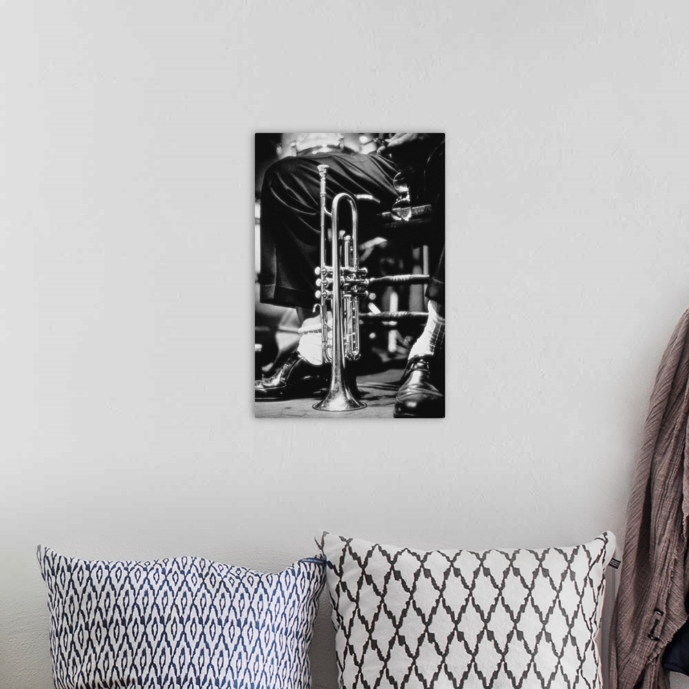 A bohemian room featuring Trumpet between jazz player's legs