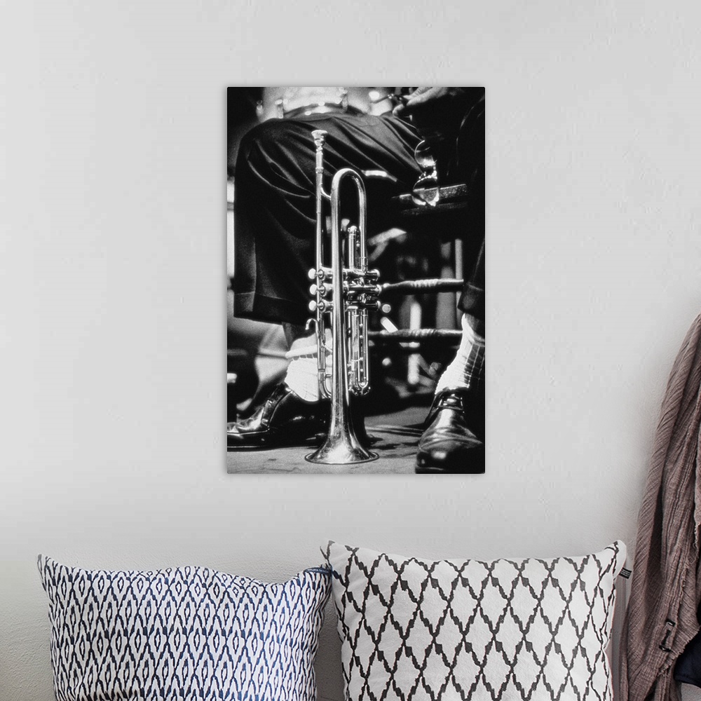 A bohemian room featuring Trumpet between jazz player's legs
