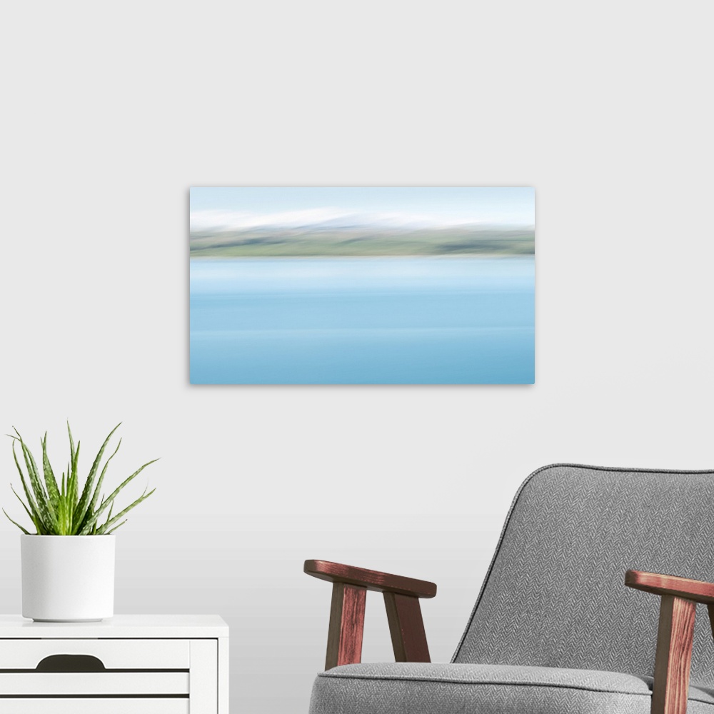 A modern room featuring Abstract image of turquoise colors of lake Pukaki with snow-capped mountains in the distance. Ima...