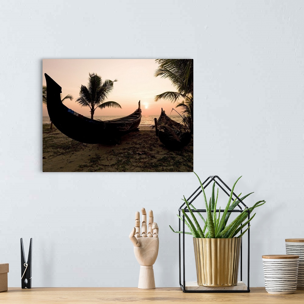A bohemian room featuring Two canoes on the beach at the Arabian Sea, Kerala, India