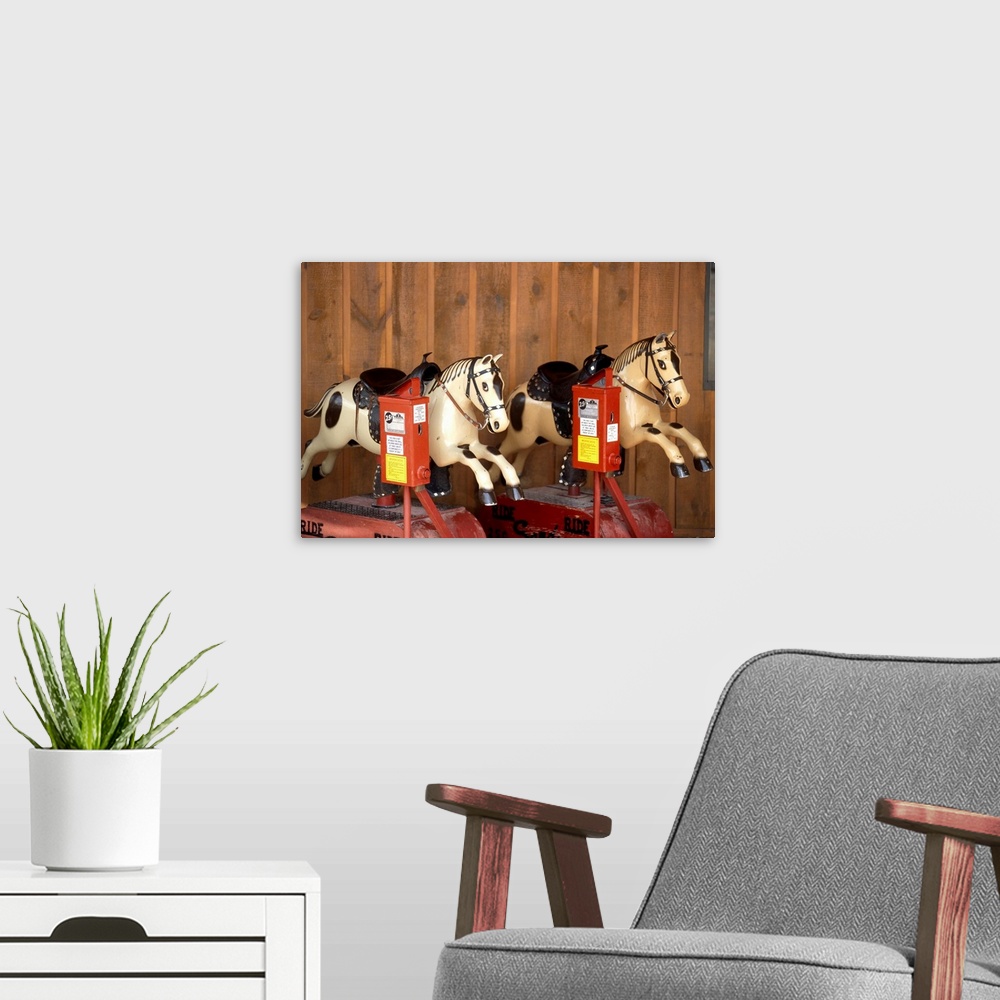 A modern room featuring Two mechanical horses