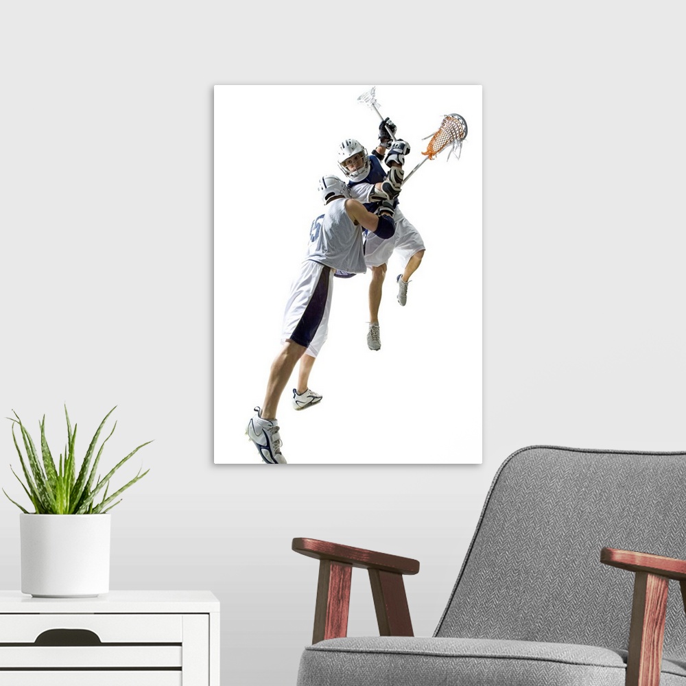 A modern room featuring Two young men playing lacrosse
