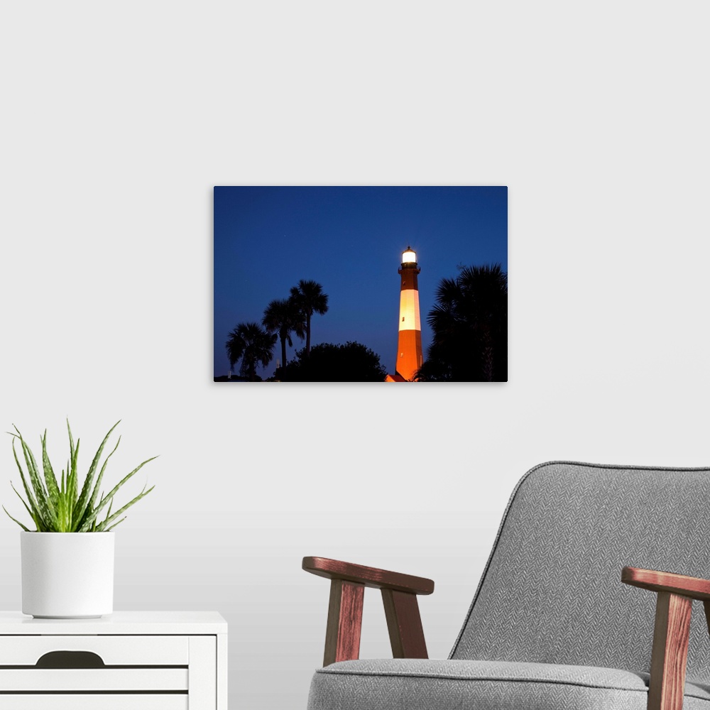 A modern room featuring USA, Georgia, Tybee Island, Palmetto Palm trees and Tybee Lighthouse at dusk on summer evening