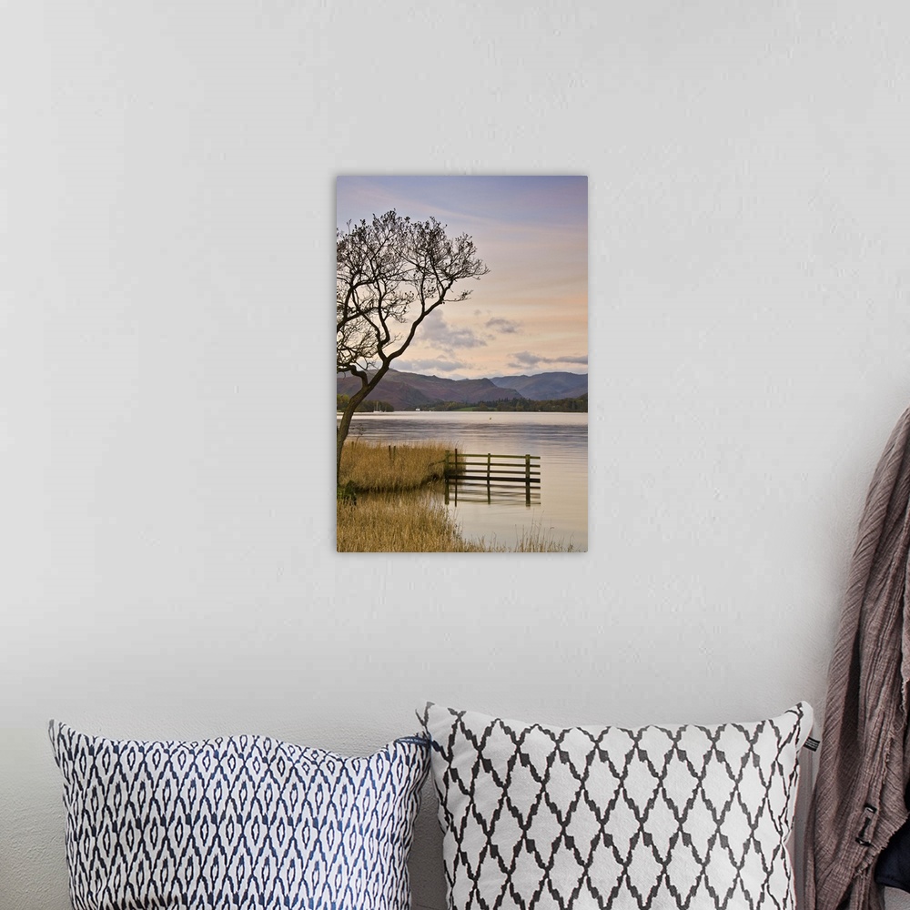 A bohemian room featuring Ullswater with fence and bare tree.