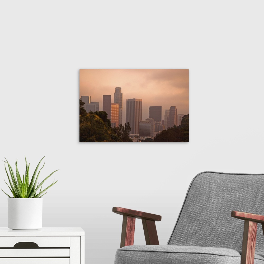 A modern room featuring Unique view of downtown Los Angeles between hills.