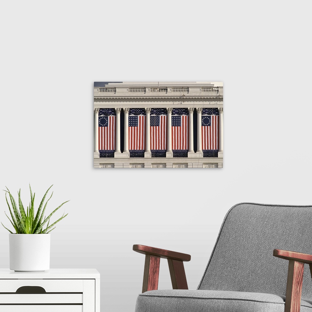 A modern room featuring US Capitol Building with American flags draped between columns