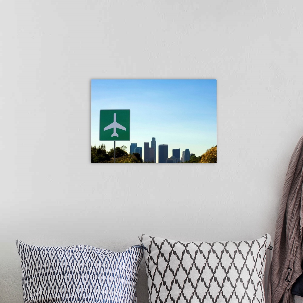 A bohemian room featuring USA, California, Los Angeles, airport sign with city skyline in background