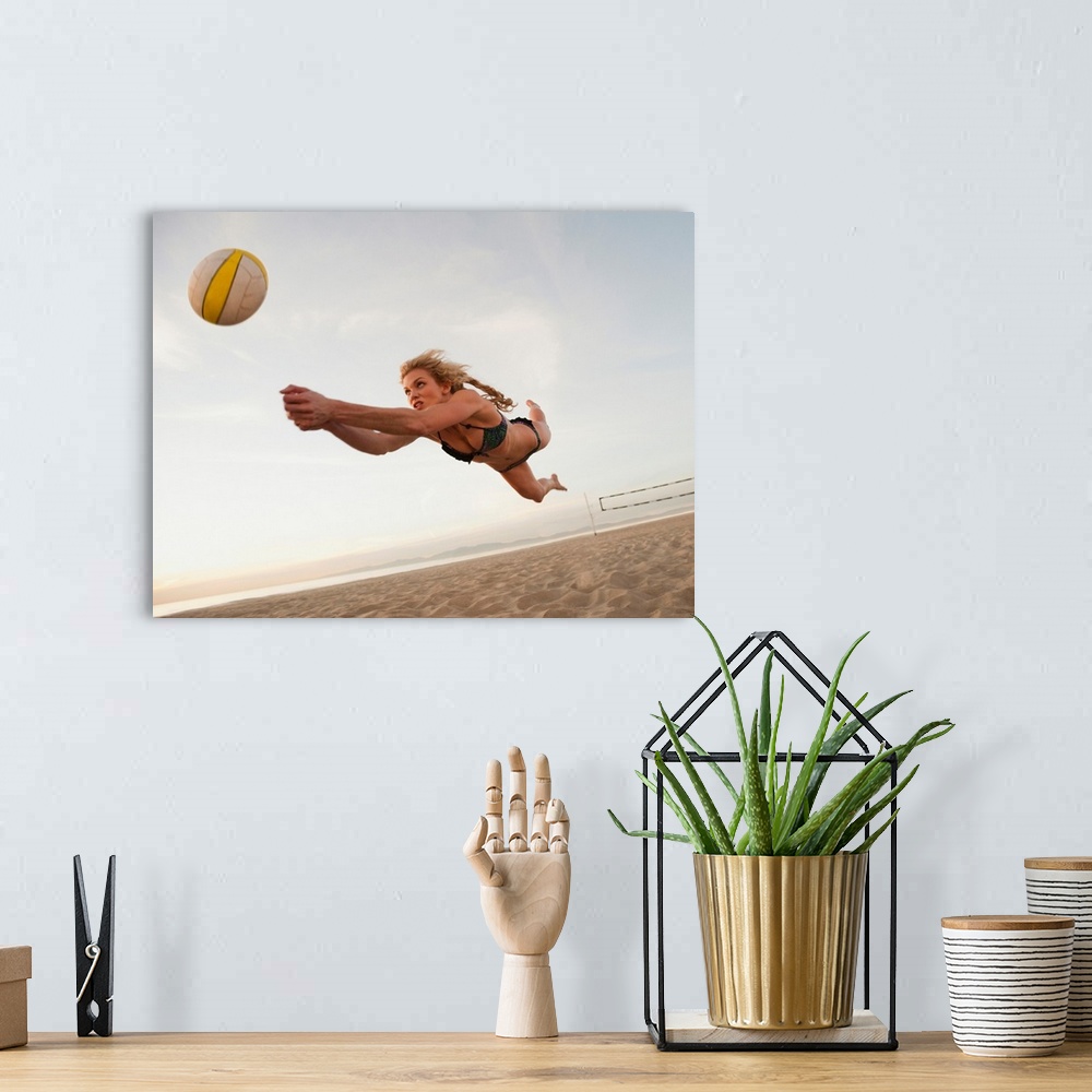 A bohemian room featuring USA, California, Los Angeles, woman playing beach volleyball