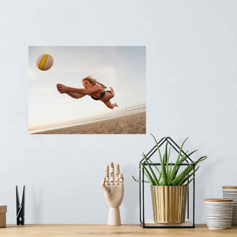A bohemian room featuring USA, California, Los Angeles, woman playing beach volleyball