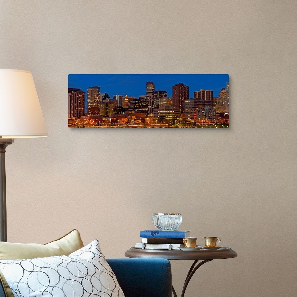 A traditional room featuring Panoramic photograph of lit up skyline under a clear sky.