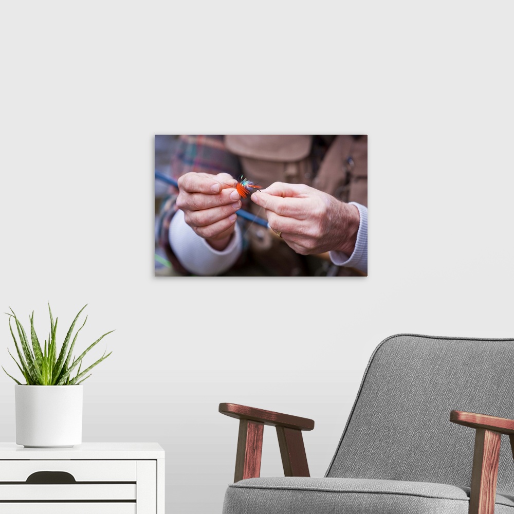 A modern room featuring USA, Washington, Vancouver, Close-up of fisherman's hands tying fly onto line