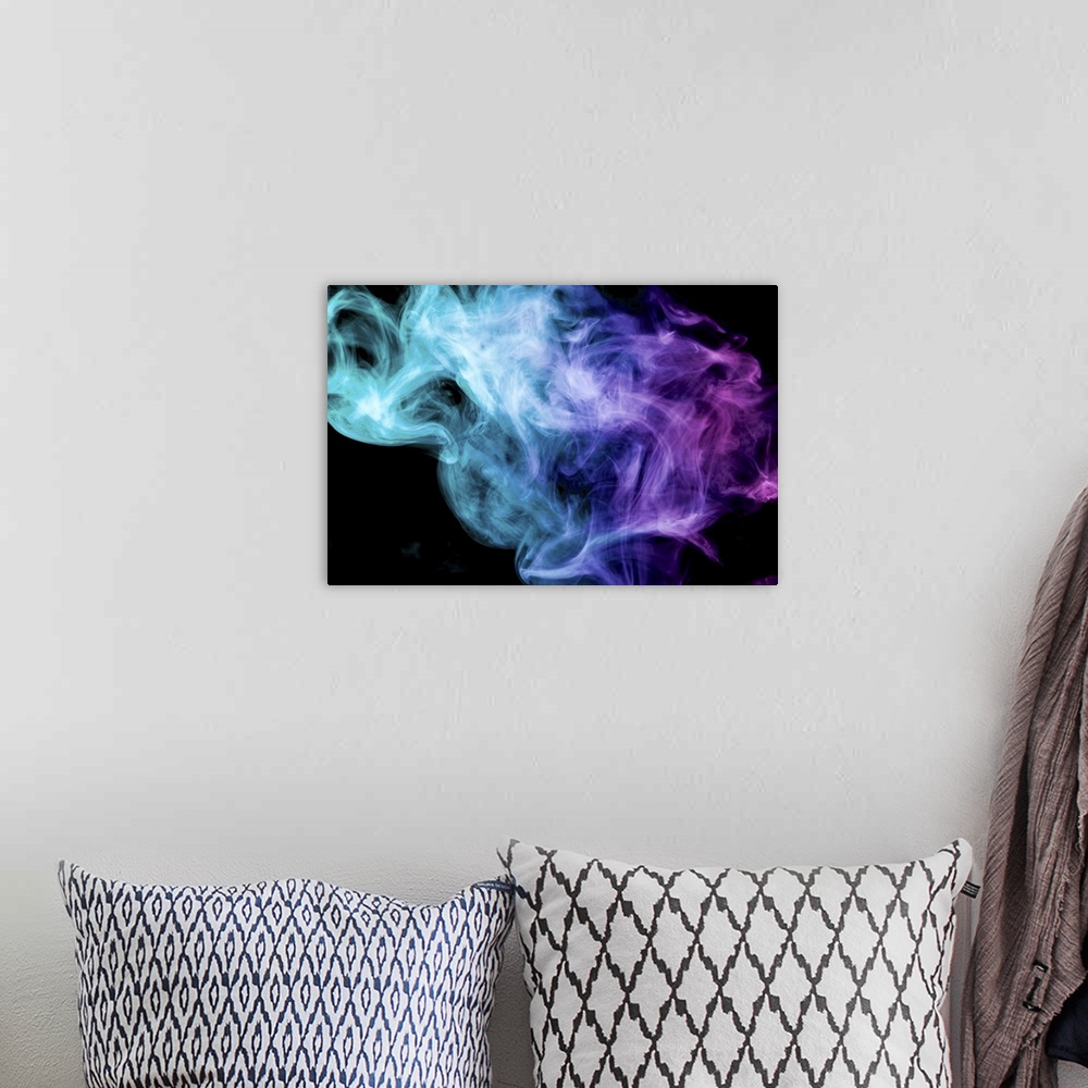 A bohemian room featuring Thick colorful smoke of blue and pink on a black background.