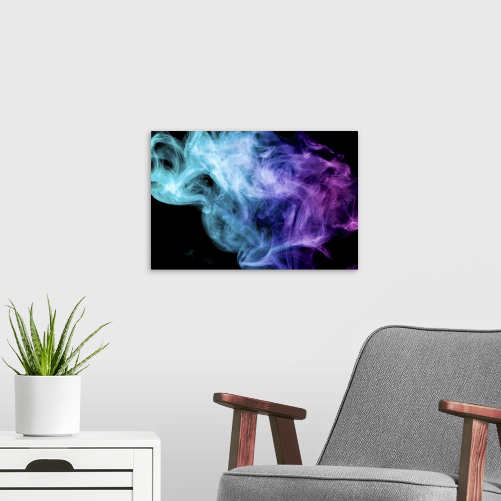 A modern room featuring Thick colorful smoke of blue and pink on a black background.