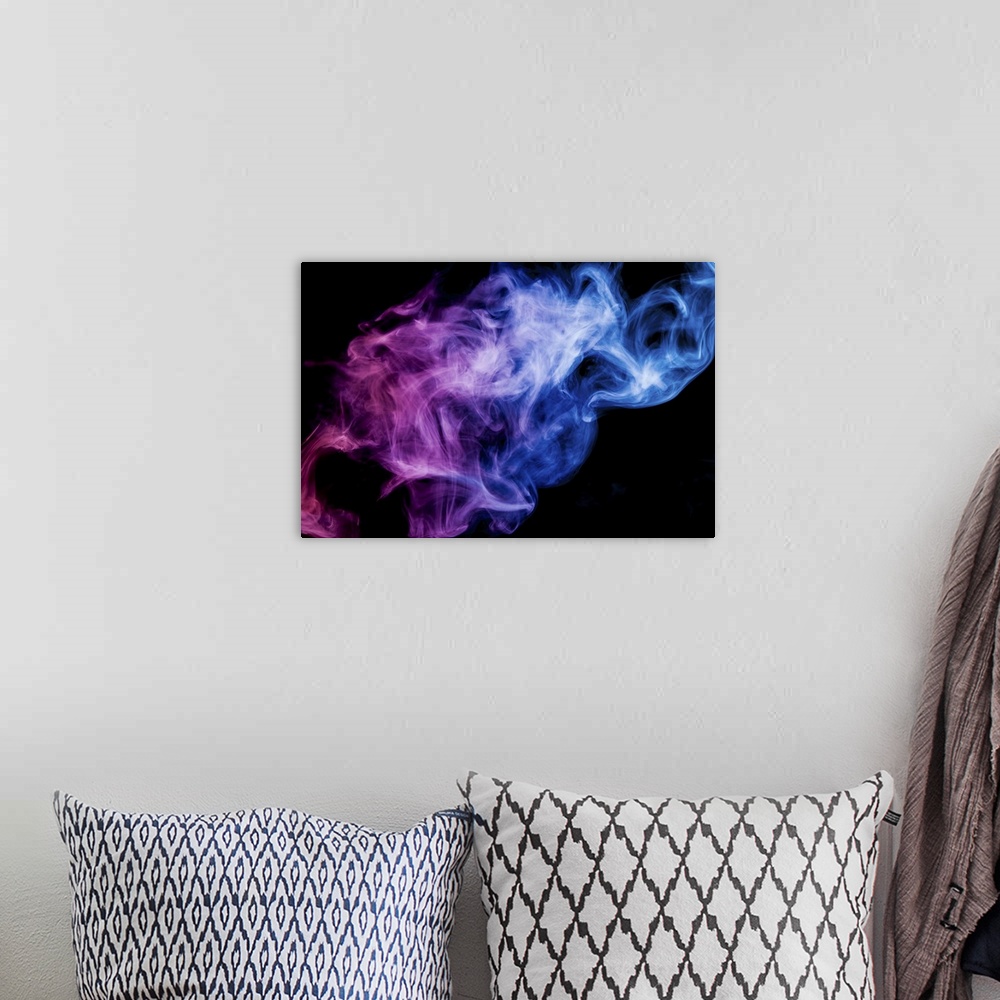 A bohemian room featuring Thick colorful smoke of blue and pink on a black background.