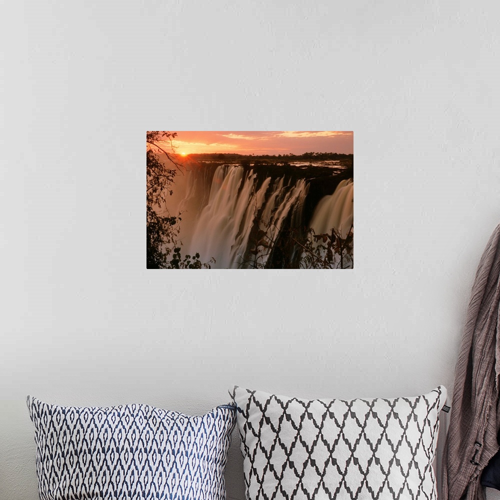 A bohemian room featuring Victoria Falls with sun on horizon, Victoria Falls, Zimbabwe