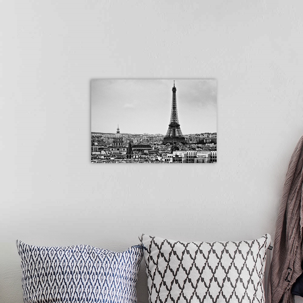 A bohemian room featuring Landscape photograph on a giant wall hanging of the Eiffel Tower, surrounded by the city of Paris...