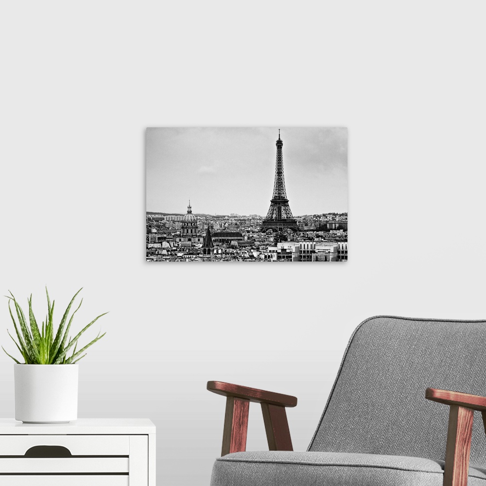 A modern room featuring Landscape photograph on a giant wall hanging of the Eiffel Tower, surrounded by the city of Paris...