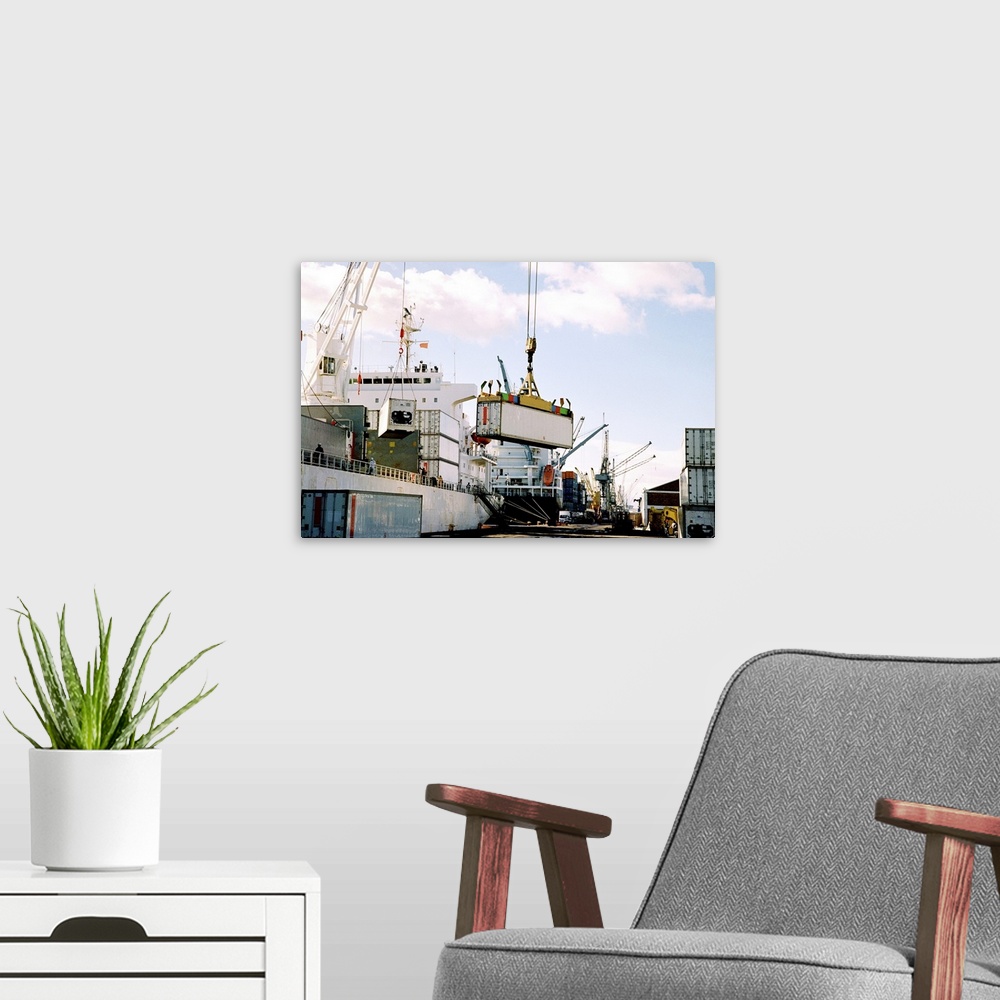 A modern room featuring View of cranes loading cargo on a ship