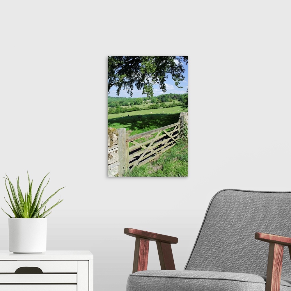 A modern room featuring View of gate and farmland in english cotswolds.