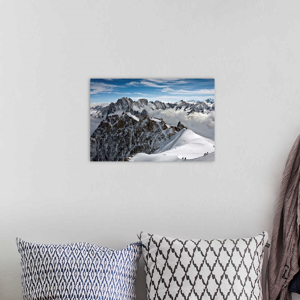 A bohemian room featuring View of Mont Blanc massif in French Alps, with alpine climbers in snow, France.