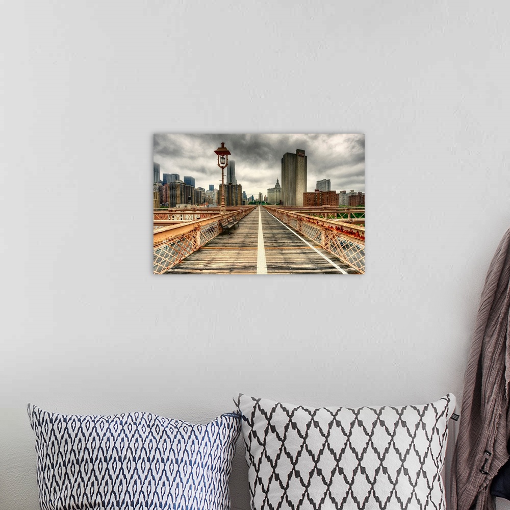 A bohemian room featuring The towering skyscrapers of New York City against a dark, cloudy sky, as seen from a weathered br...