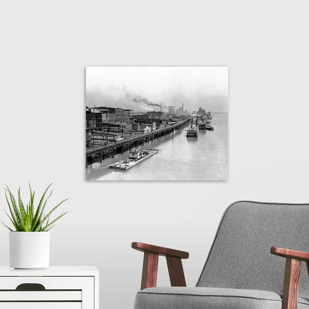 A modern room featuring Boats move down the high water of the Mississippi River in 1892, next to the waterfront.